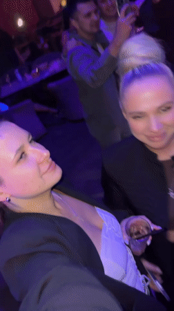 Two women sing along to music at Odintsovo nightclub