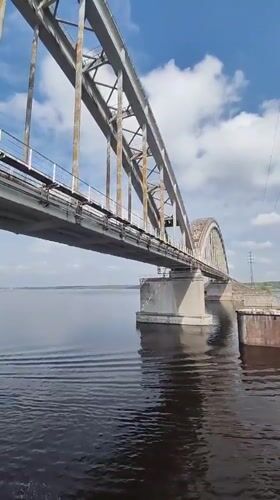 Steel bridge observed from water near Zarya, Russia