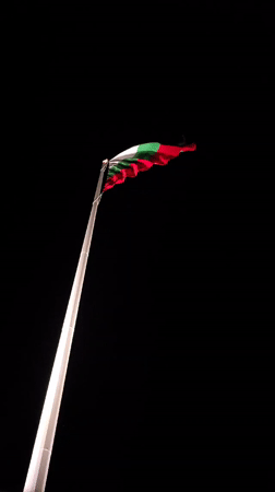Bulgarian flag flies illuminated at night in Yambol
