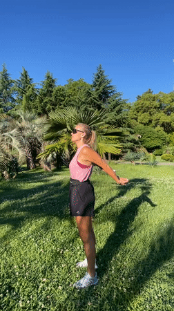 Outdoor stretching session in a Sochi park, sunny morning