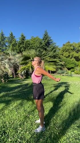 Outdoor stretching session in a Sochi park, sunny morning
