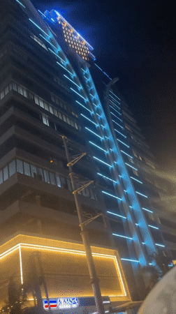 Mwanga Tower glows over Dar es Salaam's busy evening streets