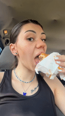 Woman eats burger in car while man mows lawn in Sofia