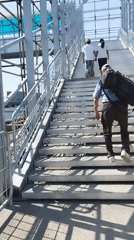 Crossing a pedestrian overpass in Bishkek with bags in hand