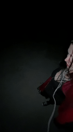 Woman in red jacket walks with earphones in Montenegro