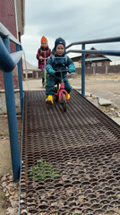 Children play on playground equipment in Chaikovsky, Russia