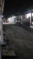 Evening in Kediri: desk work indoors, a fallen bike outside