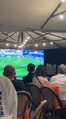 Budapest crowd watches live soccer match on outdoor screen