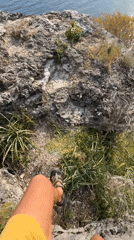 Person walks rocky cliff path in Montenegro