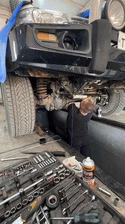 Mechanic services white SUV at Blagoveshchensk garage