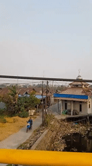 Morning traffic and riverside debris along Banjarmasin streets