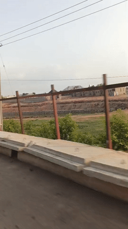 Vehicle travels waterside road in Rido, Nigeria