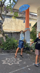 Children paint mural, play in Kediri courtyard