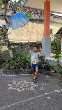 Children paint mural, play in Kediri courtyard