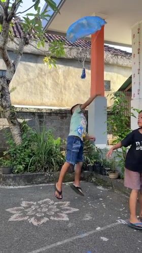 Children paint mural, play in Kediri courtyard