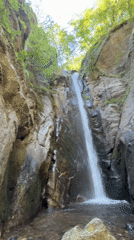 Waterfall and forest trail in Samuilovo's rocky gorge