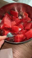 Person enjoys iced watermelon while working on Russian technical documents