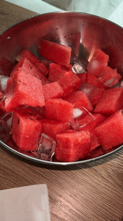 Person enjoys iced watermelon while working on Russian technical documents