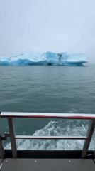 Tourist boat tours photograph icebergs at Jökulsárlón glacier lagoon