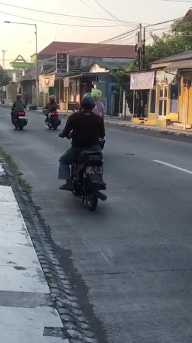 East Java neighborhood streets at golden hour, motorbikes and all