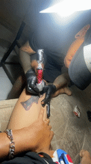 Tattoo artist creates black-grey design on client's thigh in Kuta