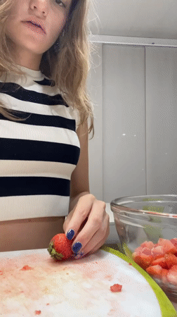 Woman prepares strawberry dish in Mexican kitchen early morning