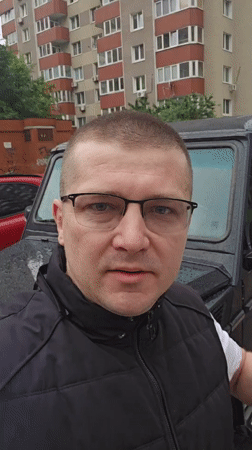 Man speaks to camera near vehicle in Kyiv