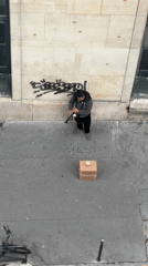 Street musician performs clarinet near Dover Street Market Paris