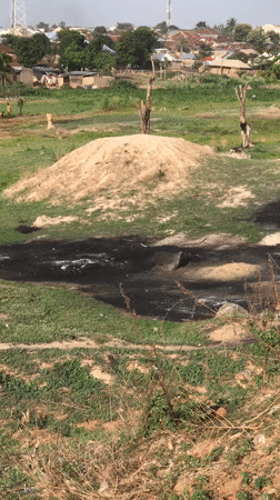 Manual earthwork and settlement activity documented in Abuja