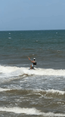 Kitesurfers launch and ride the choppy break at Mũi Né