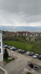 Witness documents Bansko's red-roofed buildings against mountain backdrop