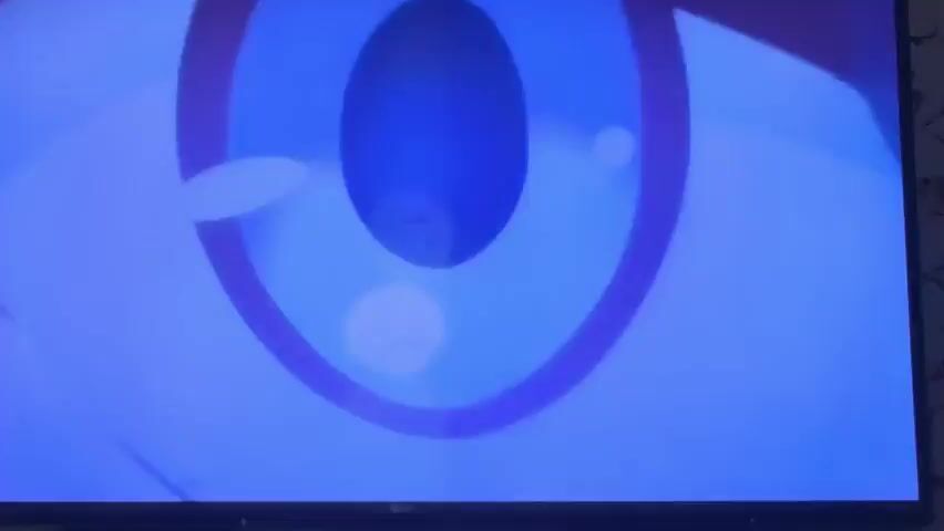 0000 is an anime style video. A young person with white hair and a dark outfit is shown in profile with a rifle. The text "Dark seeks light" appears on screen with Japanese characters. 0001 shows a close up of the white-haired character aiming the rifle. Green leaf-like objects float around the character. 0002 shows a young person with blonde hair and an orange jacket with green ribbons in their hair. 0003 shows a person's legs in a dark outfit. The text is present again on a light blue background.