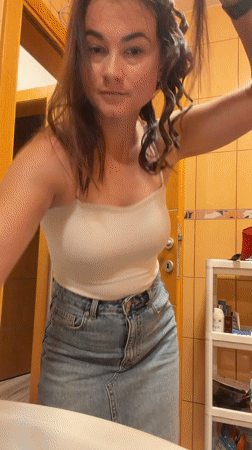 Woman styles hair in bathroom in Lastva Grbaljska, Montenegro
