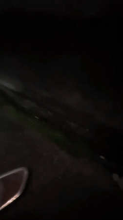 Three riders captured on nighttime scooter journey in Kuta