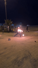 Fire spinning on Batumi's beachfront boardwalk after dark