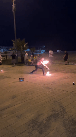 Fire spinning on Batumi's beachfront boardwalk after dark