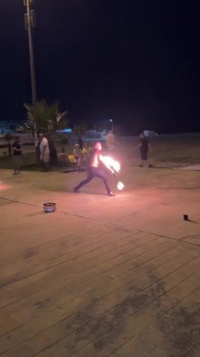 Fire spinning on Batumi's beachfront boardwalk after dark