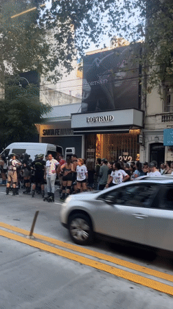 Inline skaters gather on Buenos Aires sidewalk before street event