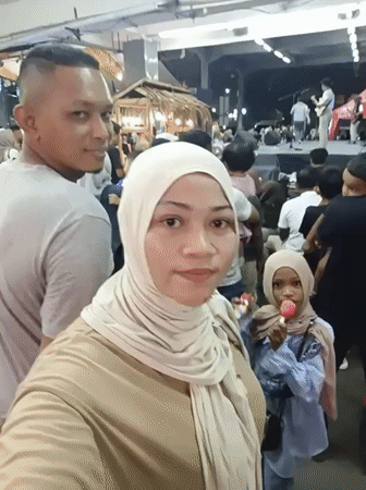Daily life unfolds in Lhokseumawe during afternoon rain