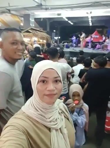 Daily life unfolds in Lhokseumawe during afternoon rain
