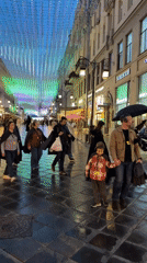 Costumed pedestrians gather on wet Moscow streets Thursday evening