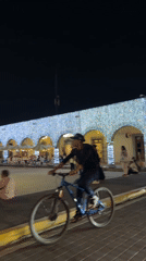 Nighttime group dance or exercise gathering in Cholula plaza