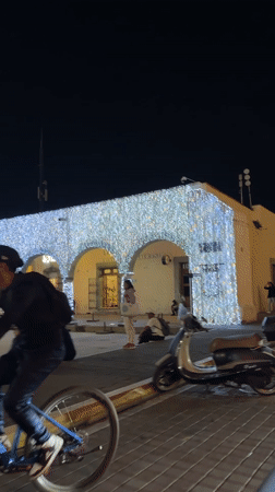 Nighttime group dance or exercise gathering in Cholula plaza