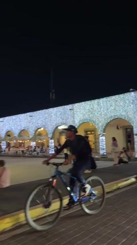 Nighttime group dance or exercise gathering in Cholula plaza