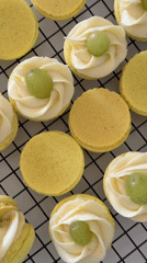 Baker arranges decorated yellow macarons in Tel Aviv