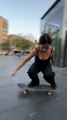 Young skateboarders practice tricks in Barcelona plaza during evening session
