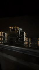 Nighttime drive captured illuminated modern buildings in Sochi