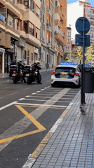 Street scenes captured in Alicante include mural, police presence