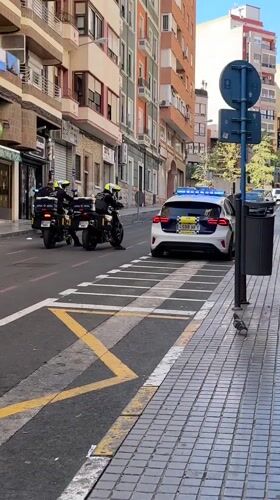 Street scenes captured in Alicante include mural, police presence