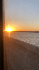 Sunset waterfront drive captured from moving vehicle in Chaikovsky